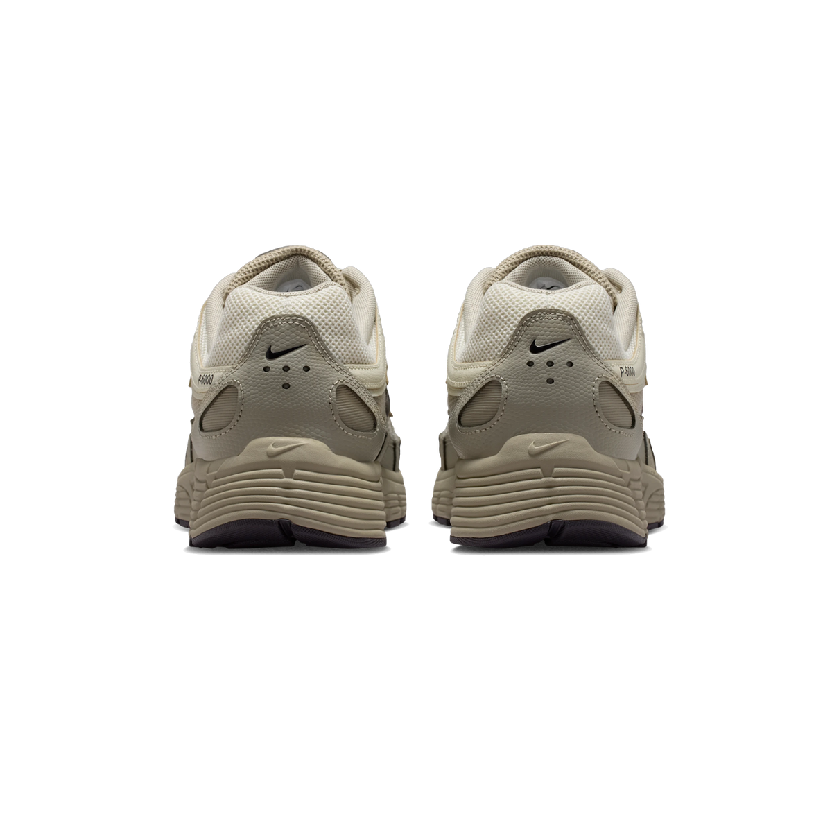 Rear view of a pair of Nike P-6000 sneakers in beige and brown tones showing ridged heel tabs with Nike swooshes and chunky ridged soles