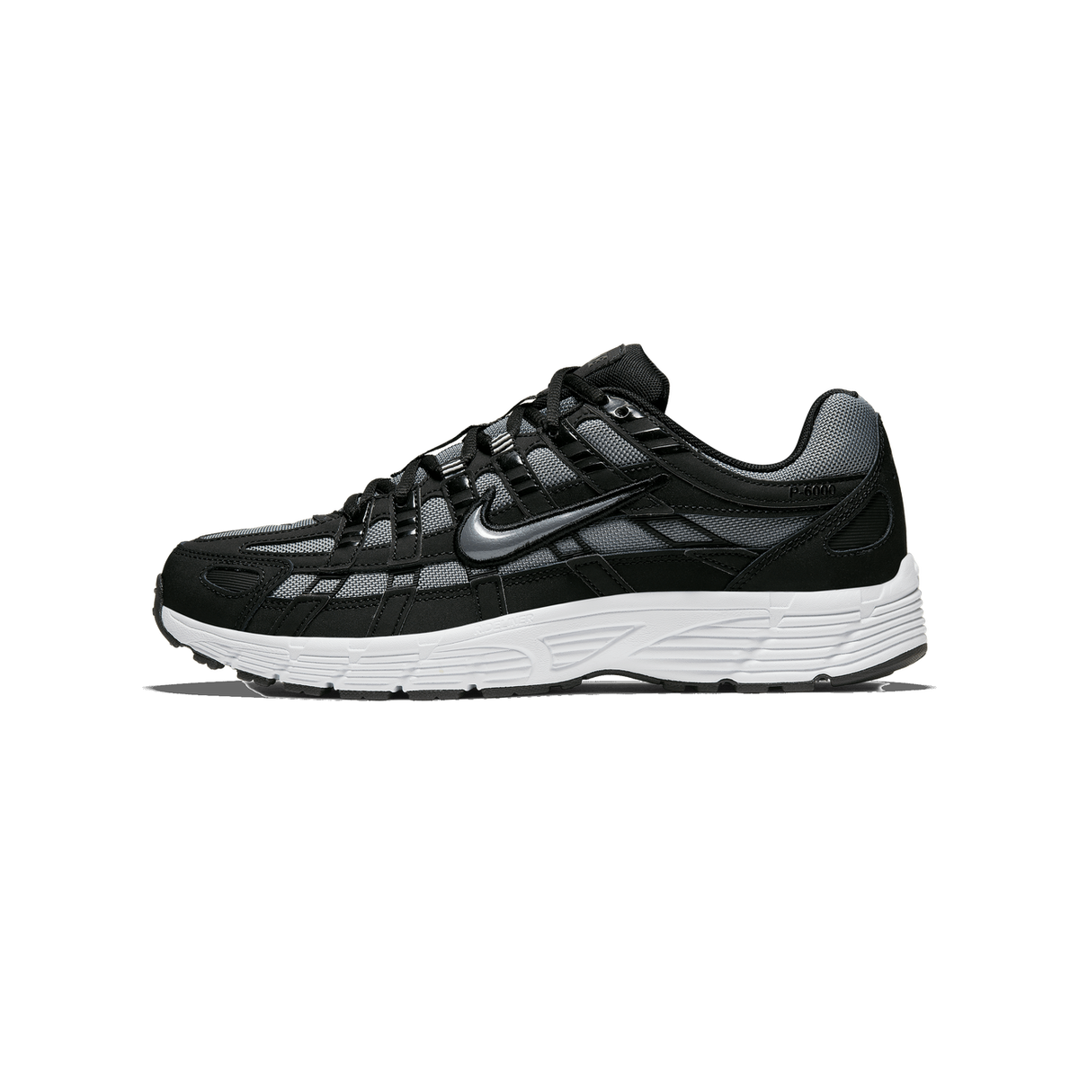 Side profile of a black and grey Nike P-6000 sneaker with the toe pointing left, showing the Swoosh logo, black and grey mesh overlays, and a white midsole with 'REACT' lettering.