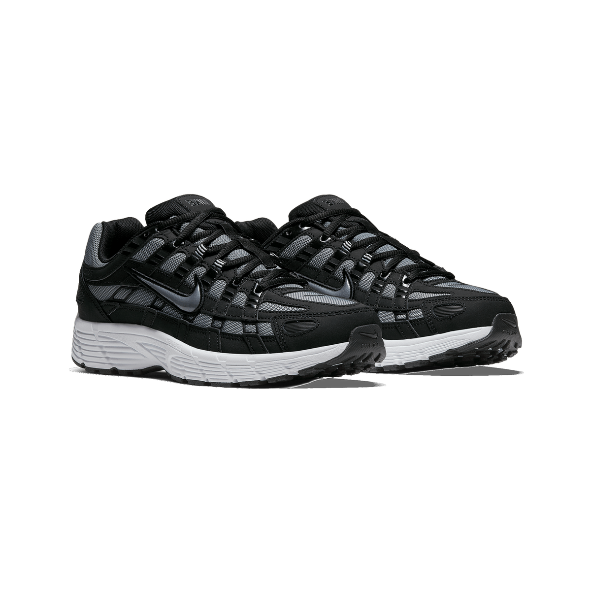 A pair of black and grey Nike P-6000 sneakers with white midsoles, shown side by side angled toward the left, with grey mesh panels and a black Swoosh on each shoe.