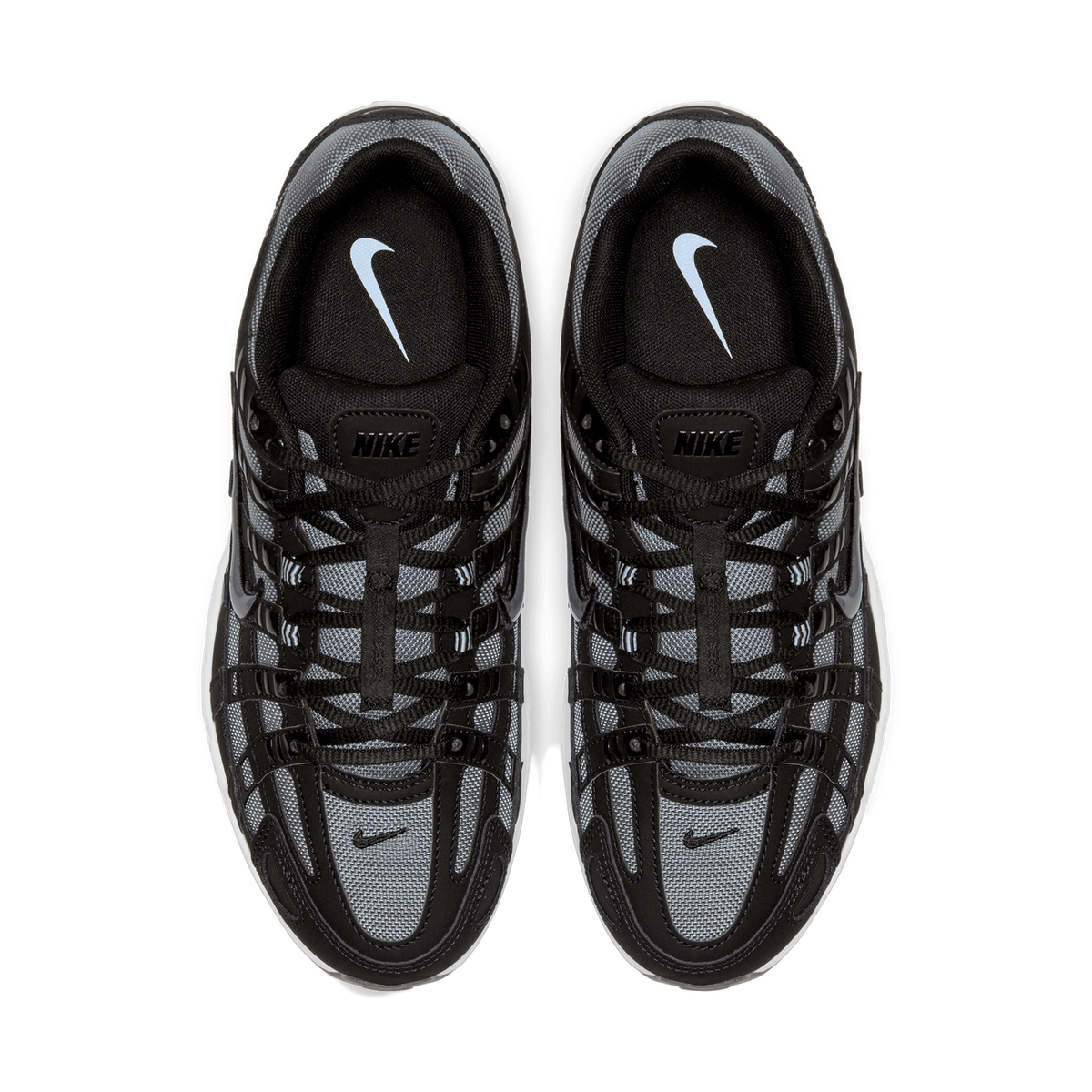 Top-down view of a pair of black and grey Nike P-6000 sneakers placed side by side, showing the tongues with light blue Nike swoosh logos, black laces, and grey mesh overlays.