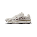 Side profile of a cream-white Nike P-6000 sneaker with a toe pointing left, showing a dark brown outlined Swoosh logo, brown trim accents, a tan midsole stripe, and a 'P-6000' label on the heel panel.