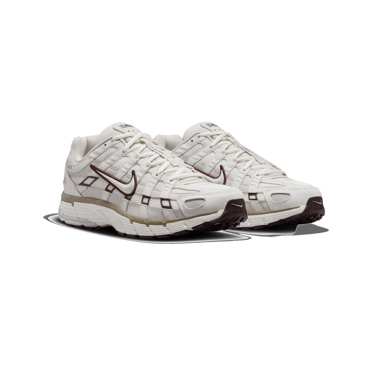 Pair of cream and off-white Nike P-6000 sneakers shown side by side at a three-quarter angle, with dark brown Swoosh logos, brown accents and tan midsole details visible.