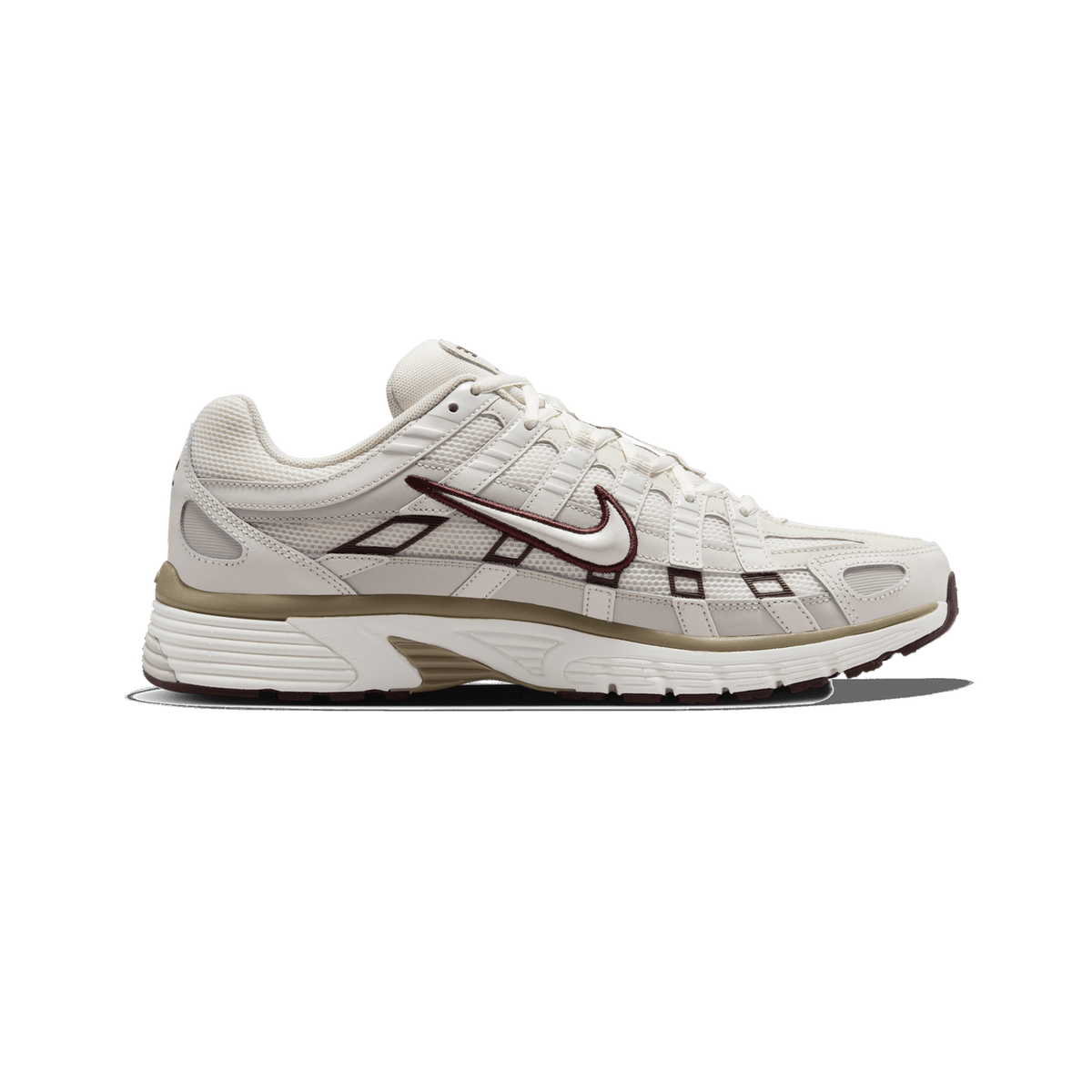 Side profile of a Nike P-6000 sneaker in bone and beige tones, toe pointing left, showing the embroidered Swoosh logo with a dark burgundy outline, mesh and synthetic overlays, and a tan midsole stripe with a white sole.