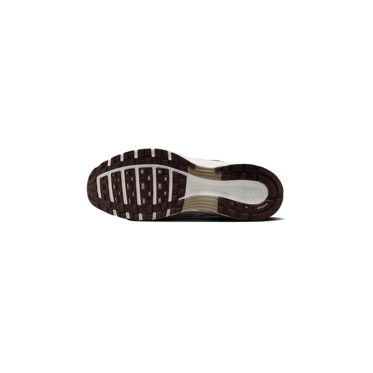 Underside of a Nike P-6000 sneaker showing a dark brown lugged outsole with cream midsole sections, tan accents, and the Nike logo on the heel area.