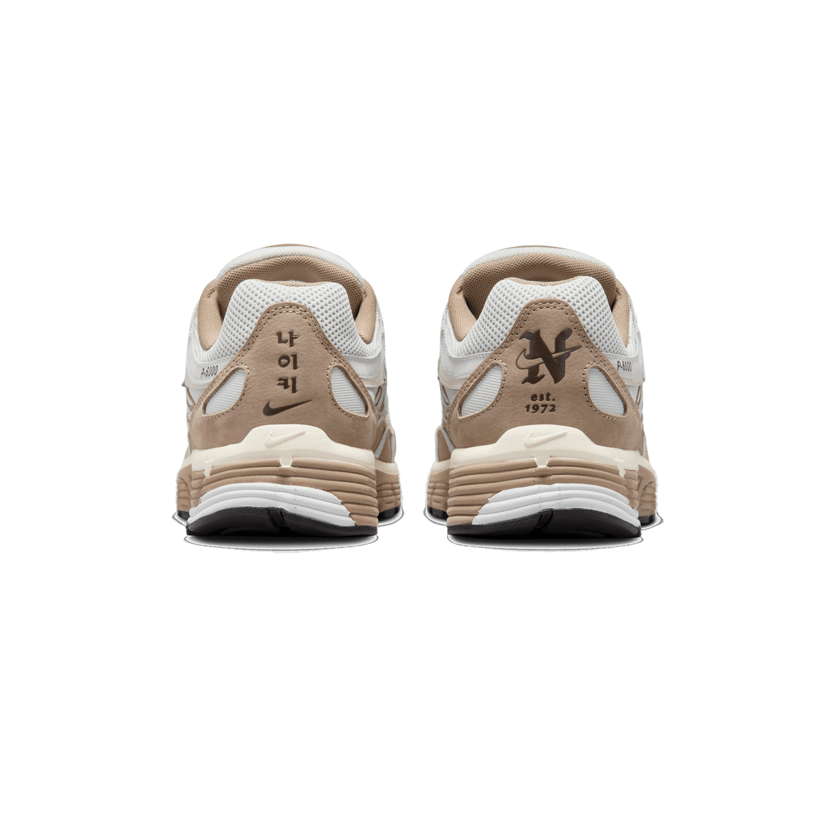 Rear view of a pair of Nike P-6000 sneakers, showing the heel counters with Korean Hangul lettering, a Nike Swoosh, 'est. 1972' and a stylised N logo, in white, tan and brown tones.
