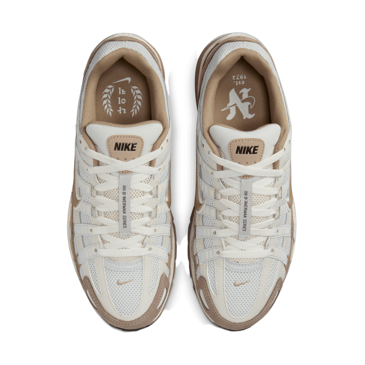 Overhead top-down view of a pair of cream, off-white and tan Nike P-6000 sneakers placed side by side, showing the laced tongues with NIKE tongue labels, the mesh and suede overlays, and the printed insoles.