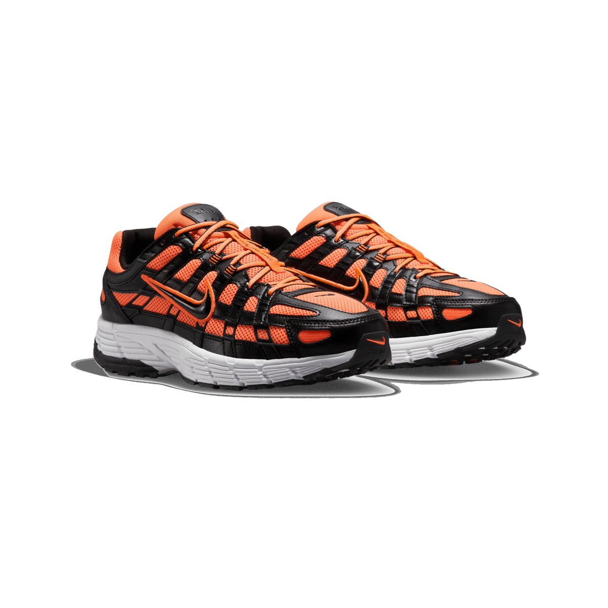 A pair of orange, black and white Nike P-6000 sneakers shown side by side, angled toward the left, with orange mesh panels, black leather overlays, orange laces and white midsoles against a plain white background.