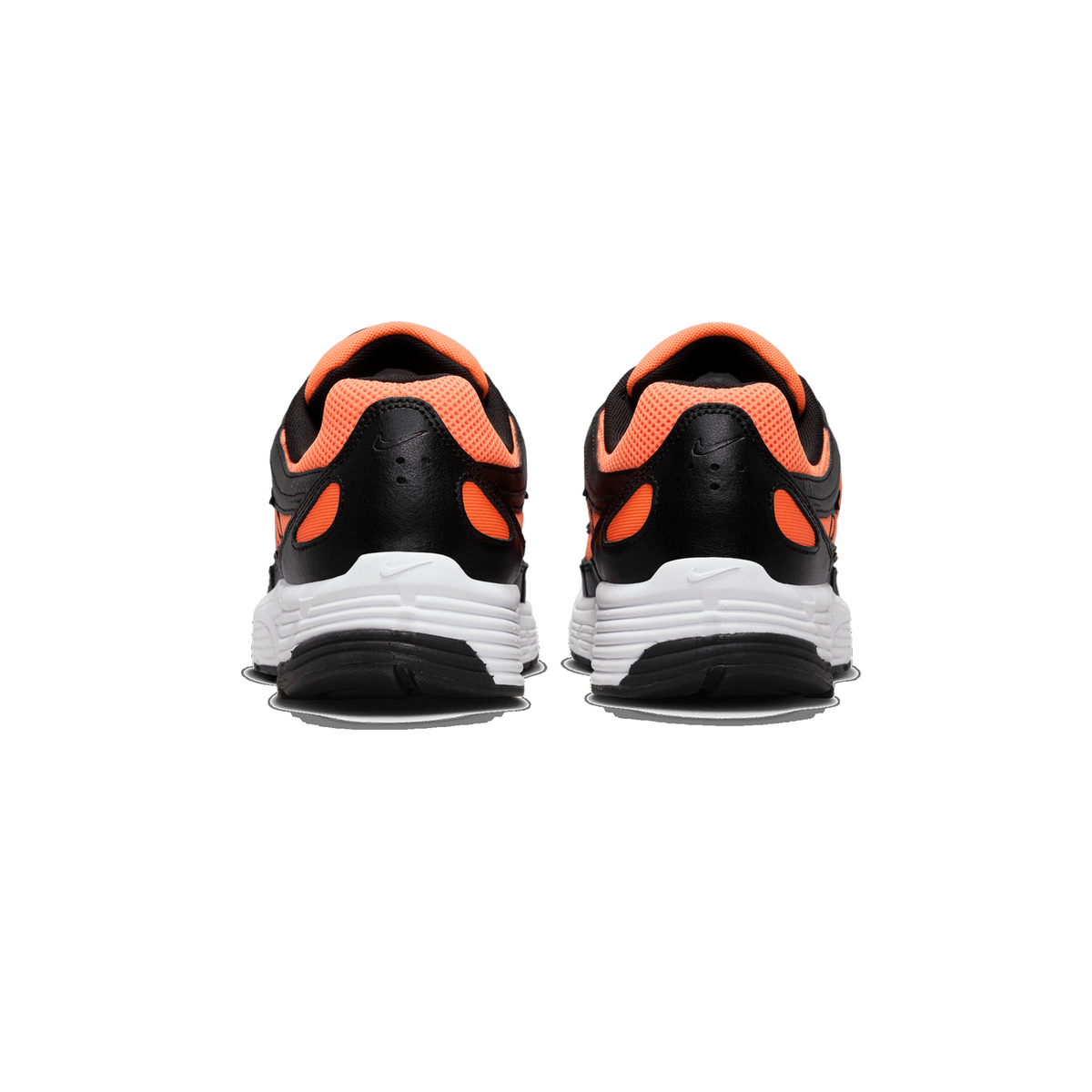Rear view of a pair of Nike P-6000 sneakers side by side, showing black leather heel counters with orange mesh accents, white midsoles and black outsole edges.