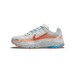 Side profile of a white Nike P-6000 Makeway Party 6000 sneaker with a toe pointing left, showing orange Swoosh logo, peach and orange overlay panels, light blue laces, 'PARTY 6000' text on the heel area, and a multicolour sole with orange and blue ac