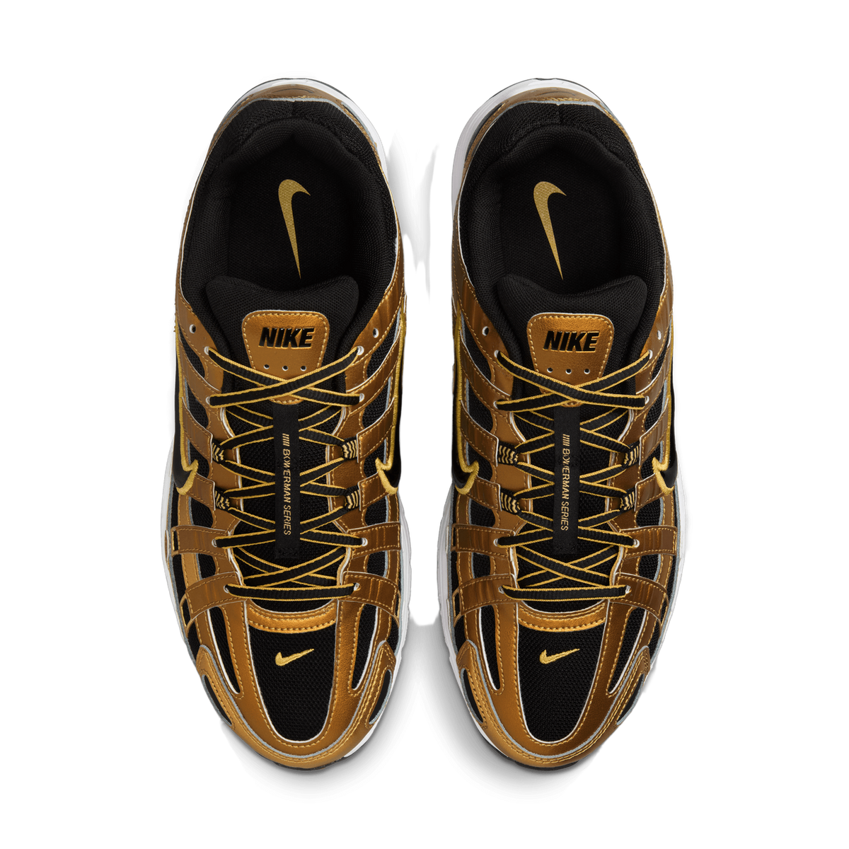 Top-down view of a pair of Nike P-6000 sneakers placed side by side, showing metallic gold overlays, black mesh panels, yellow laces, and black and gold Nike swoosh logos on the tongues and heel tabs.