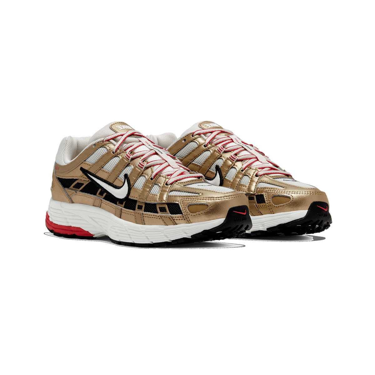 Pair of Nike P-6000 sneakers in metallic gold and white with black overlays, white swoosh, and red accents on the midsole, angled toward the front-left.