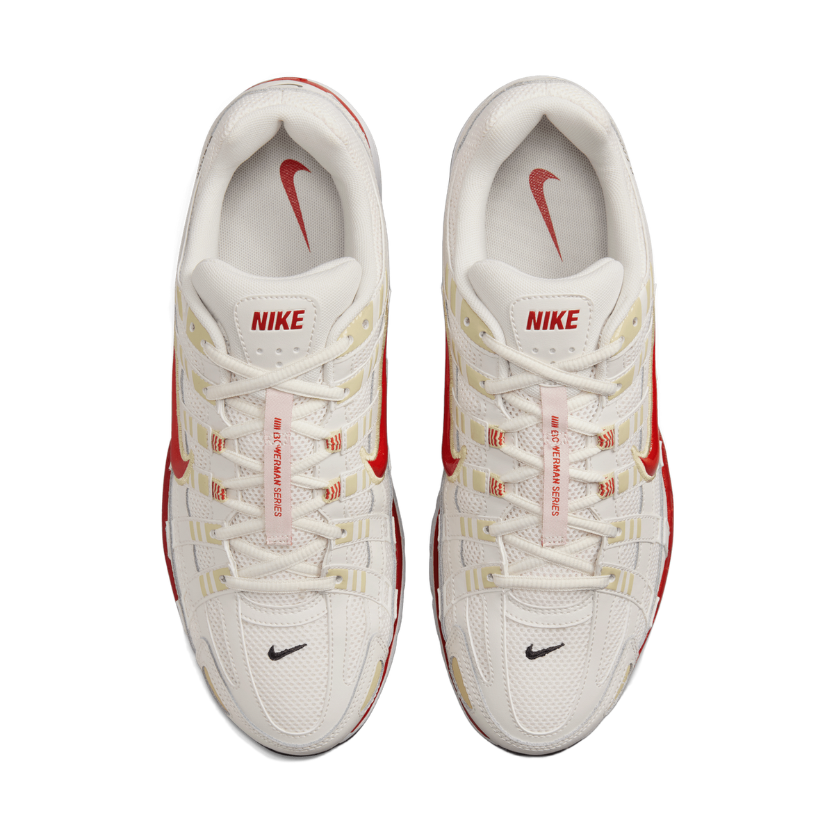 Top-down view of a pair of white Nike P-6000 sneakers placed side by side, toes pointing up, showing the red Swoosh logos, cream and gold overlays, and the red NIKE heel tab and tongue details.