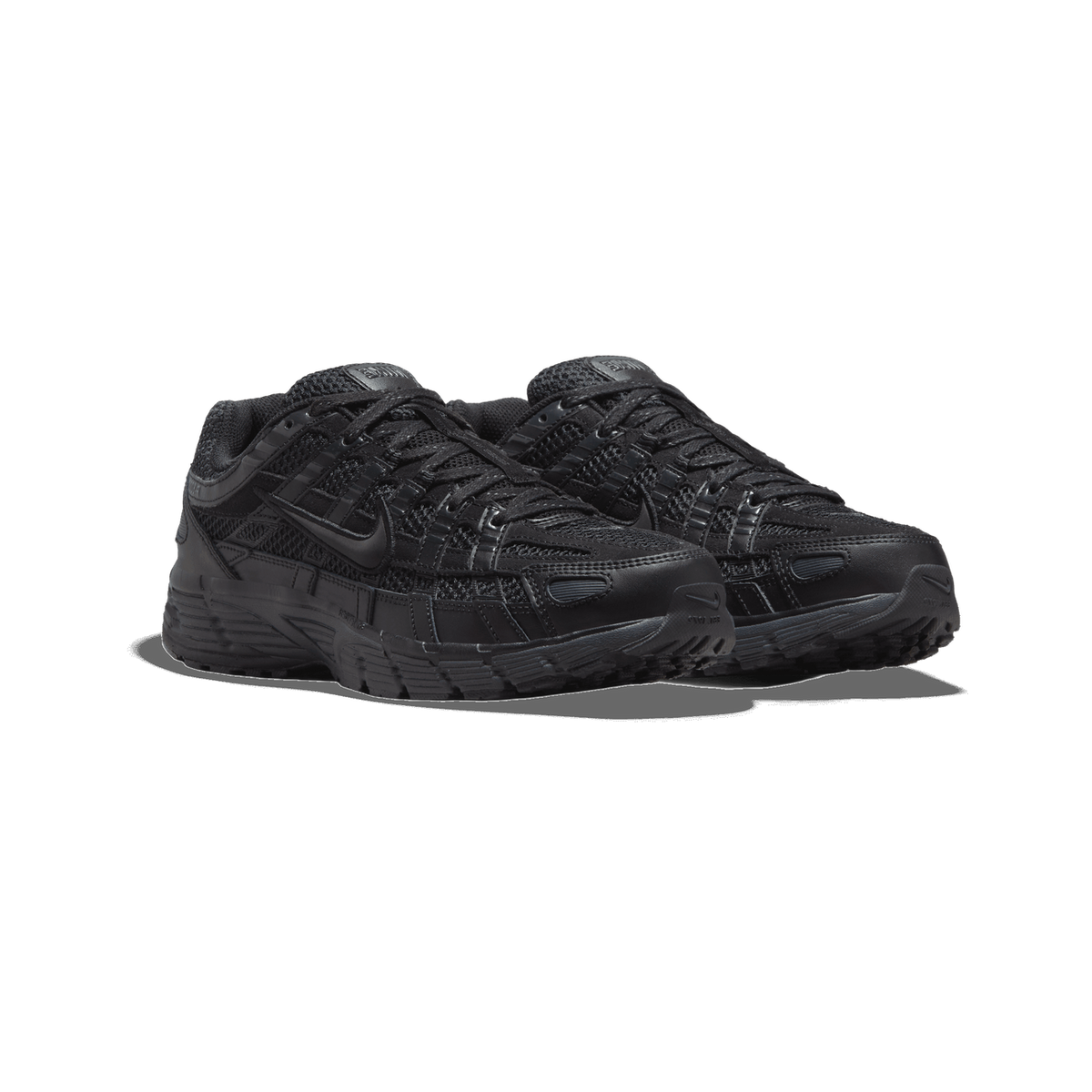 A pair of black Nike P-6000 sneakers shown side by side at a three-quarter angle, with black mesh and leather panels, black laces, and the Swoosh logo visible on the side of the toe-forward shoe.