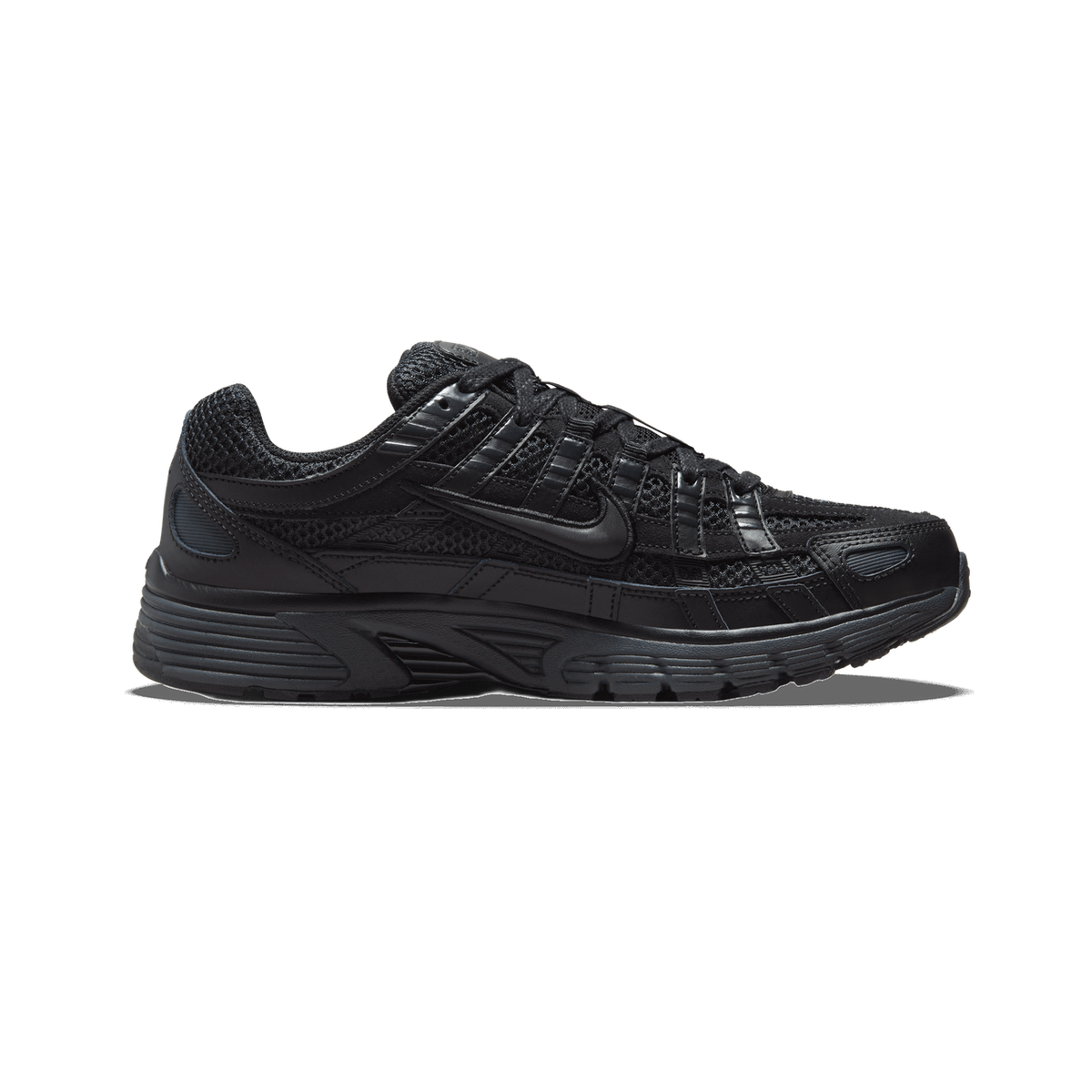 Side profile of a black Nike P-6000 Premium sneaker with the toe pointing left, showing black mesh panels, black leather overlays, and the Nike Swoosh logo on the side.