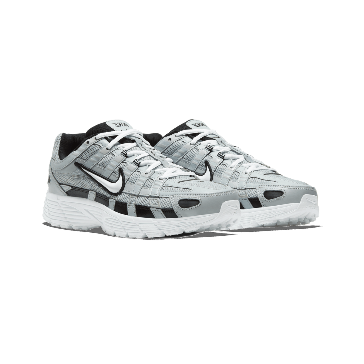 A pair of Nike P-6000 sneakers in silver-grey mesh and leather with black and white accents, shown side by side angled toward the left, with white laces and a white midsole.