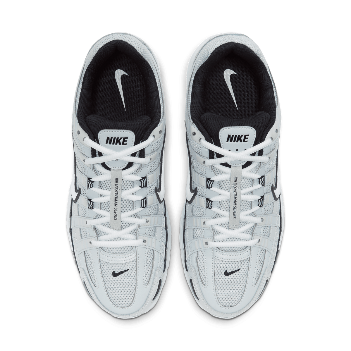 Top-down view of a pair of light grey and white Nike P-6000 sneakers placed side by side with toes pointing up, showing the black tongue and collar lining, white laces, and the Nike logo on the insole.