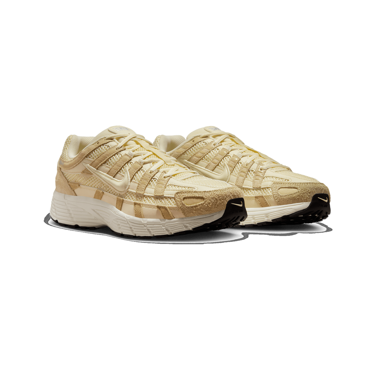 A pair of cream and beige Nike P-6000 sneakers shown side by side at a three-quarter angle, with mesh panels, tan suede overlays, and black-and-cream rubber soles visible.