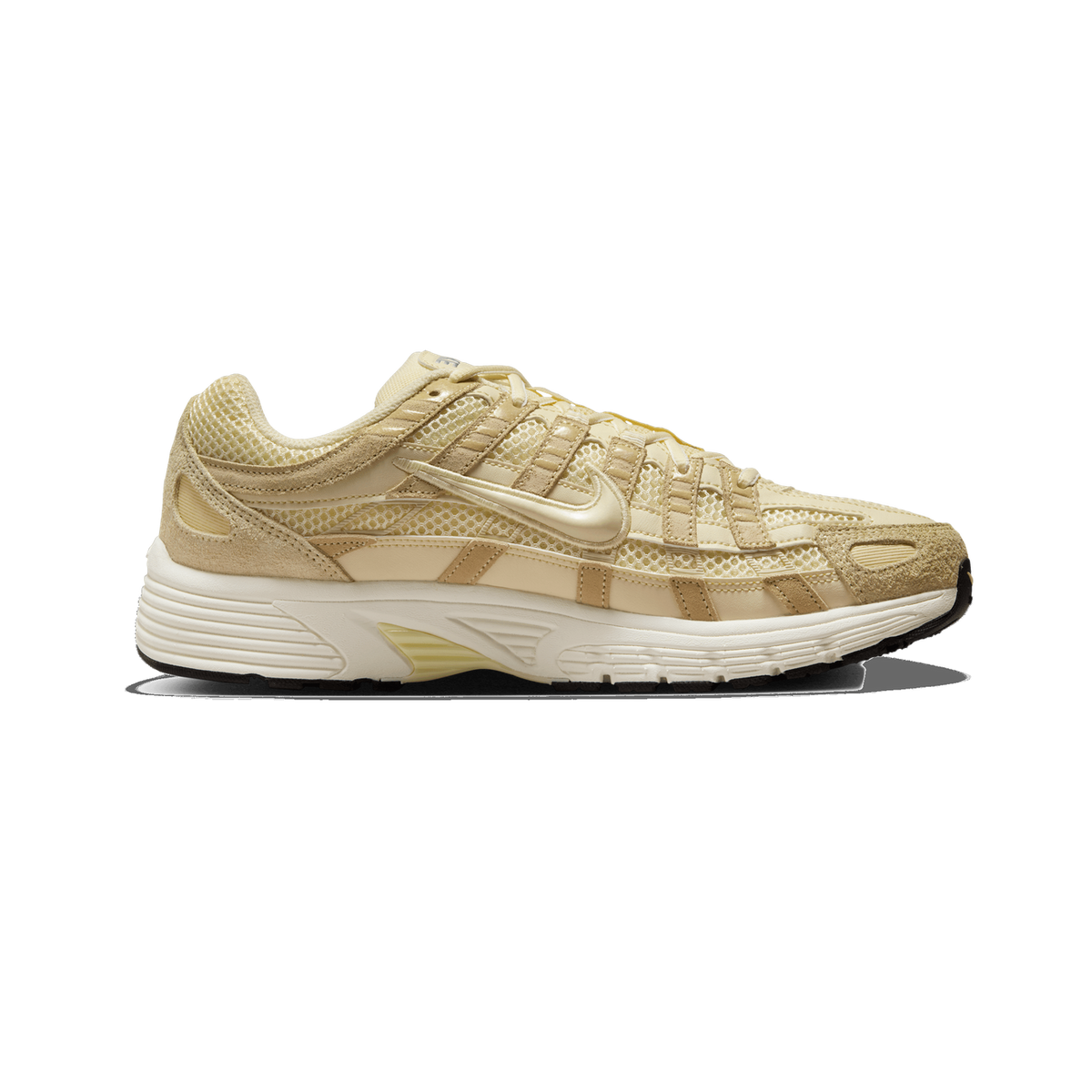 Side profile of a single beige and cream Nike P-6000 sneaker with its toe pointing left, showing a mesh and suede upper, a tonal swoosh logo on the side, and a cream rubber midsole with a black outsole edge.