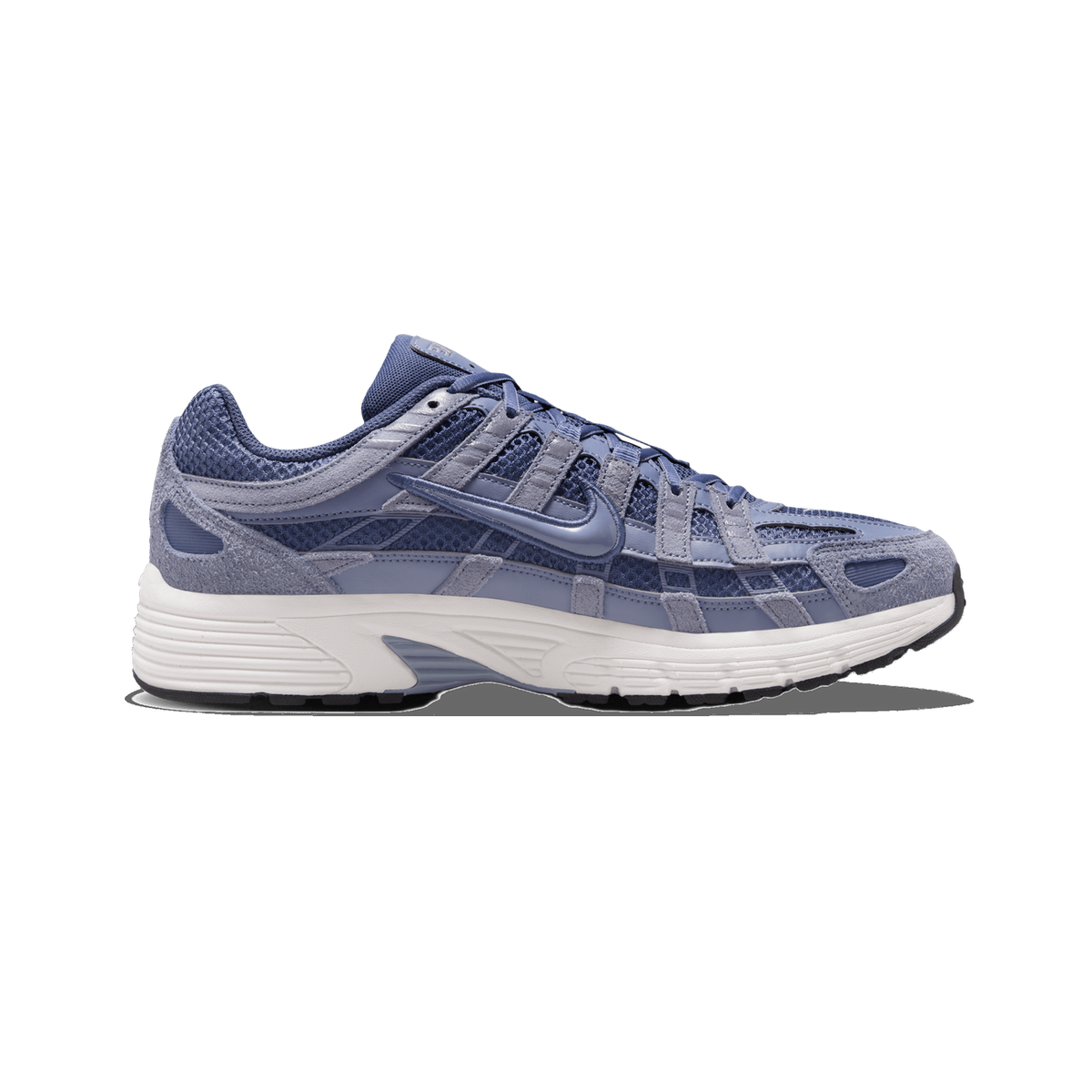 Side profile of a single blue and gray Nike P-6000 sneaker with the toe pointing left, showing the mesh and suede upper, the Swoosh logo on the side, and a white midsole with a dark rubber outsole.
