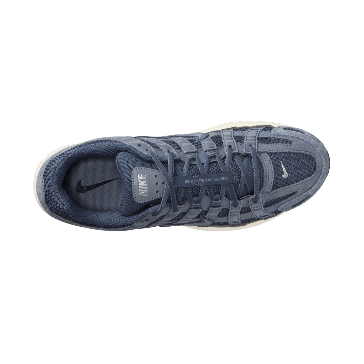 Top-down view of a single blue and gray Nike P-6000 sneaker with laces and tongue visible, showing the mesh and suede upper, the Nike logo on the tongue and heel lining, and the cream-colored midsole edge.