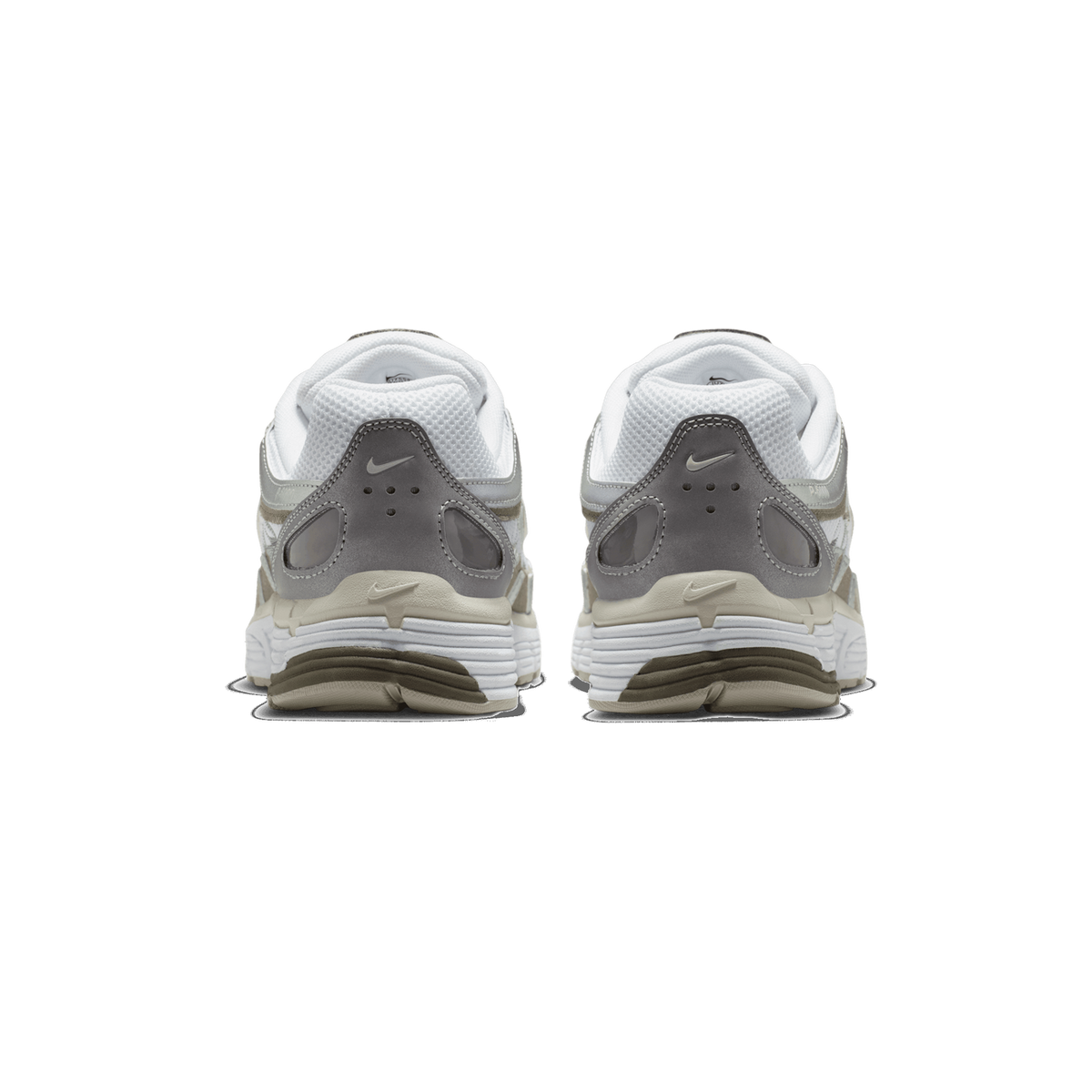Rear view of a pair of Nike P-6000 sneakers showing white mesh heels, grey leather heel counters with Nike swooshes, and a two-tone beige and grey ridged outsole.