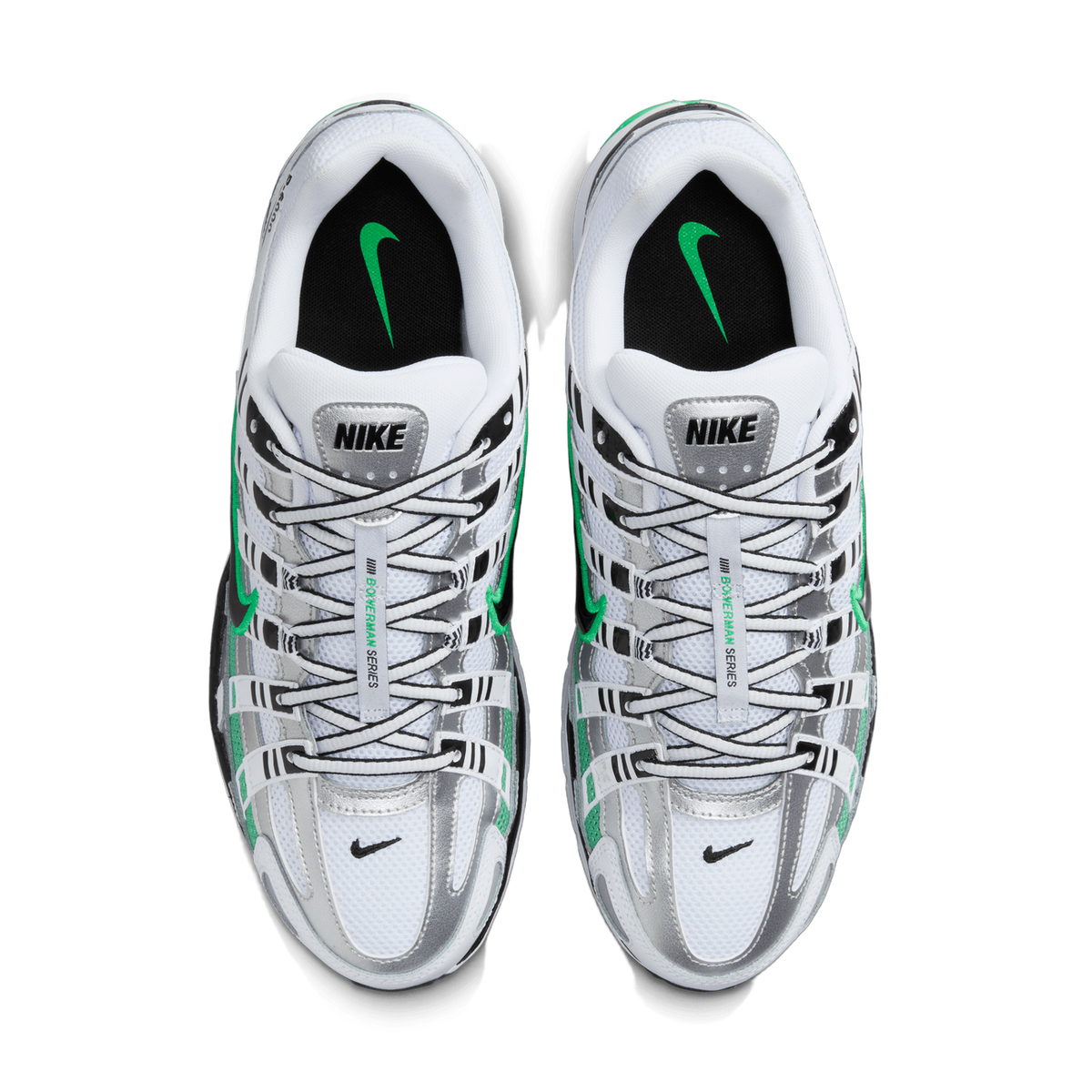 Top-down view of a pair of Nike P-6000 sneakers placed side by side, showing white, silver metallic, and green overlays with black accents, black insoles bearing green Swoosh logos, and the NIKE tongue label visible between the laces.