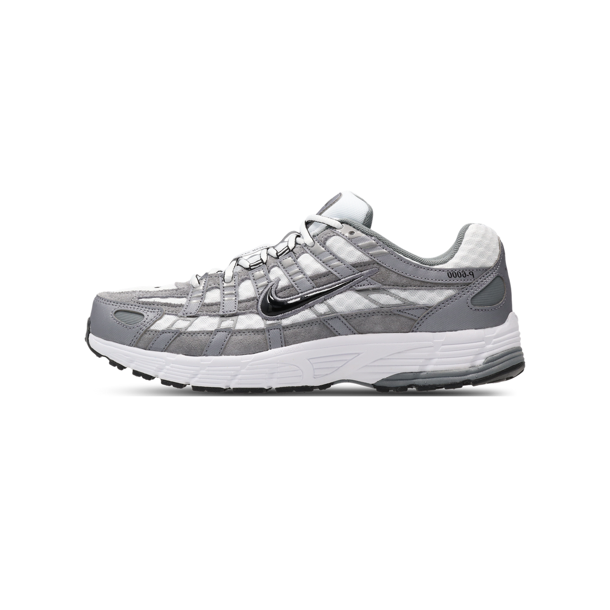 Side view of a white and grey Nike P-6000 sneaker with black Swoosh logo, toe pointing left, showing layered mesh and suede panels and chunky white midsole.