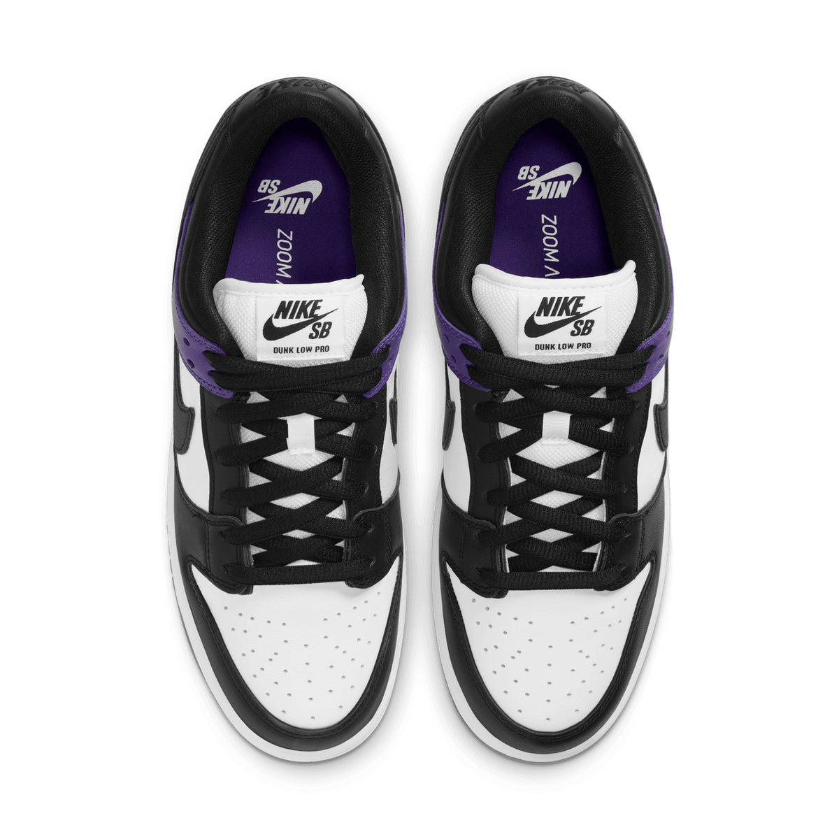 Top-down view of a pair of black and white Nike SB Dunk Low Pro sneakers with purple heel tabs and purple insoles showing the Nike SB logo, laces pointing toward viewer.