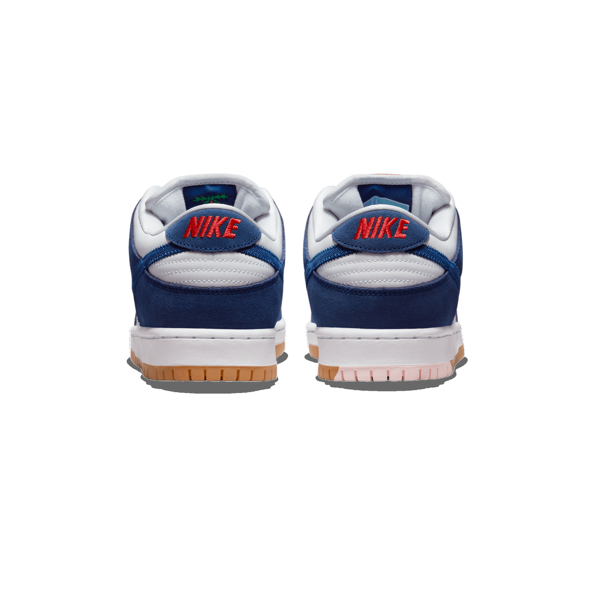 Rear view of a pair of Nike SB Dunk Low sneakers in navy blue and white with red Nike heel branding and a gum rubber outsole
