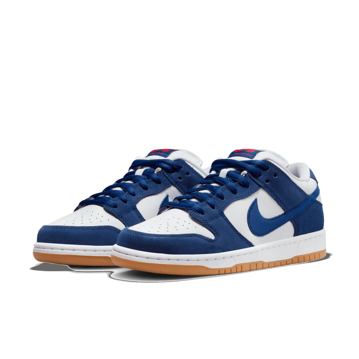 Pair of navy blue and white Nike SB Dunk Low sneakers with gum rubber soles, shown at an angled front view with toes pointing left.