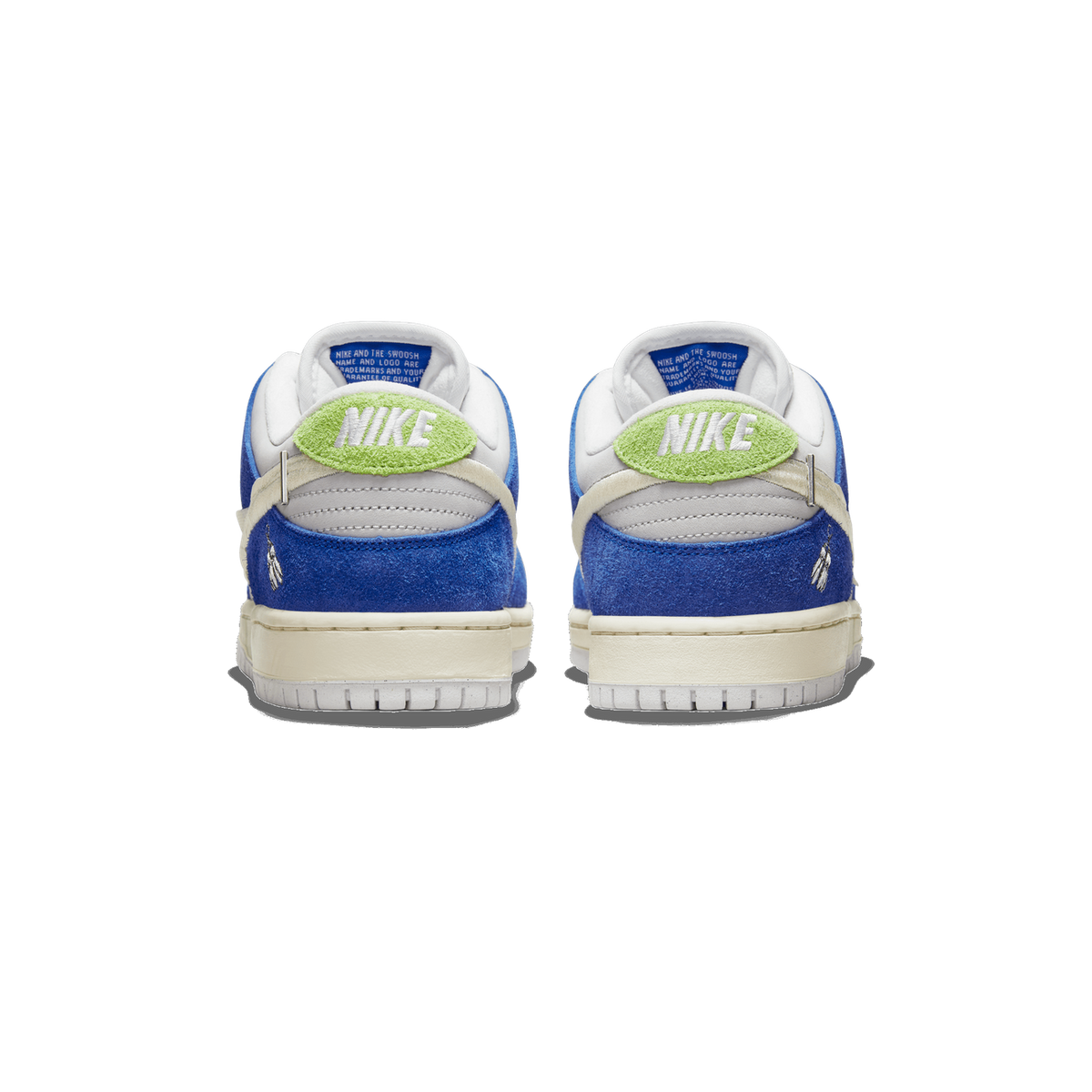 Rear view of a pair of blue suede Nike SB Dunk Low sneakers with green Nike heel tabs, cream midsoles, and small wing charms on the heels