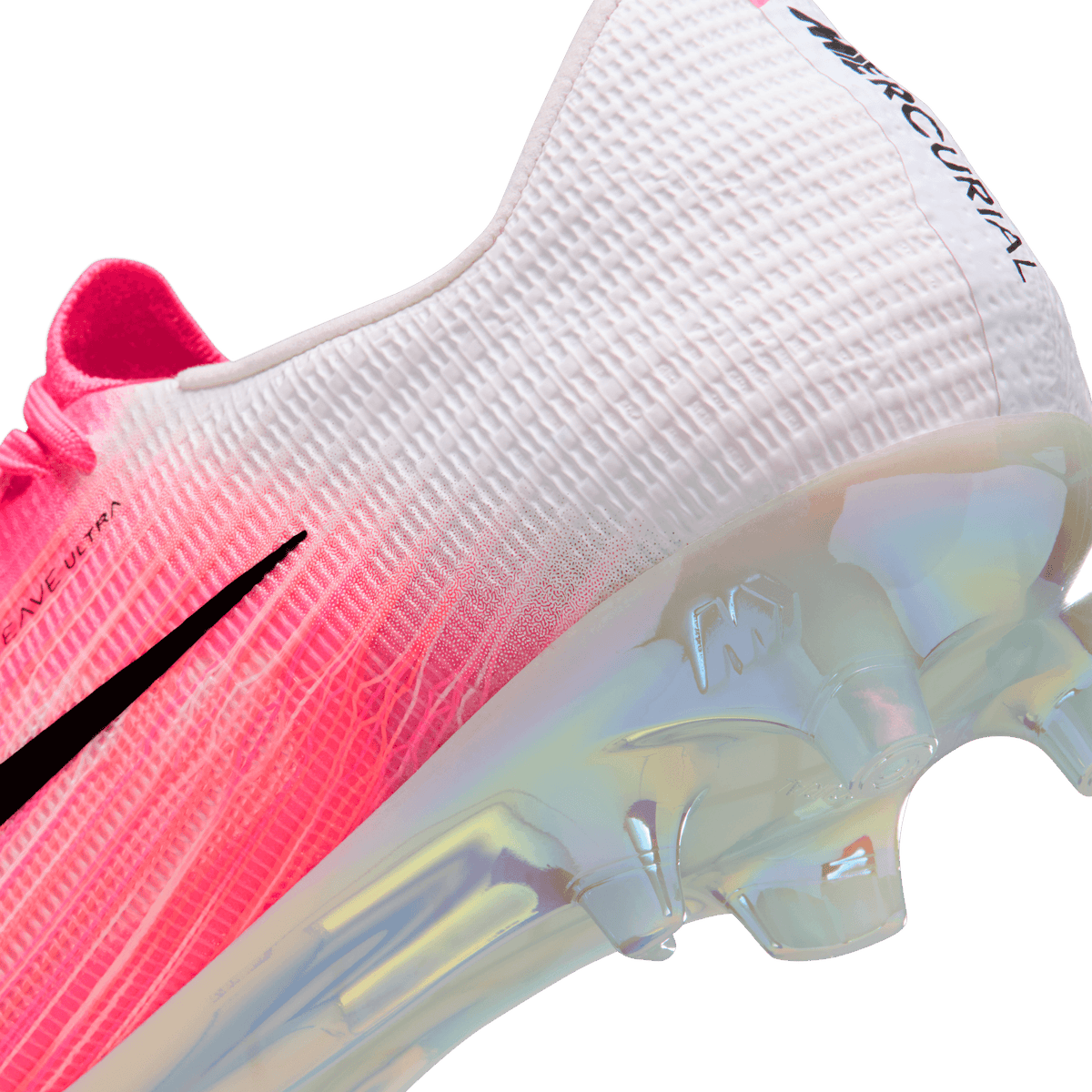 Close-up angled view of a Nike Mercurial Superfly soccer cleat showing the pink-to-white woven upper, black swoosh, and iridescent translucent sole plate with studs.
