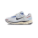 Side view of a white Nike Zoom Vomero 5 sneaker with light blue mesh panels, navy swoosh, maroon accent stripe, and a cream chunky midsole