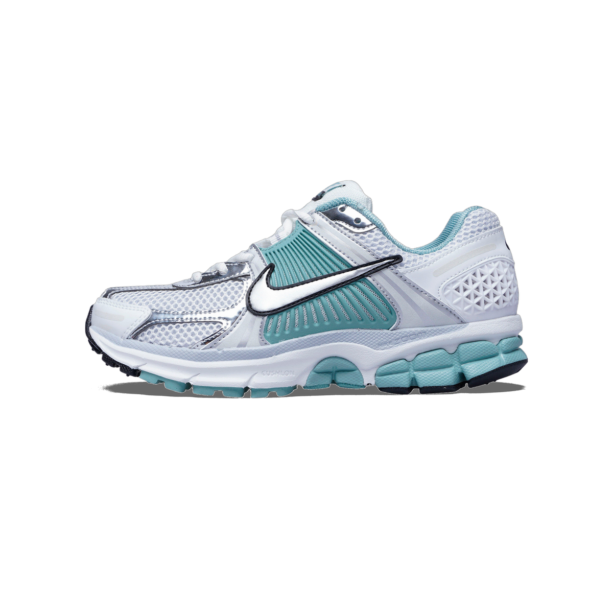 Side view of a white Nike Zoom Vomero 5 running shoe with teal accents, metallic silver overlays, and a teal textured outsole, toe pointing left.