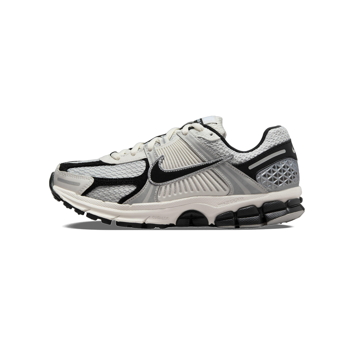 Side view of a grey, black, and silver Nike Zoom Vomero 5 running shoe with mesh upper and chunky segmented outsole, toe pointing left.