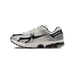 Side view of a grey, black, and silver Nike Zoom Vomero 5 running shoe with mesh upper and chunky segmented outsole, toe pointing left.
