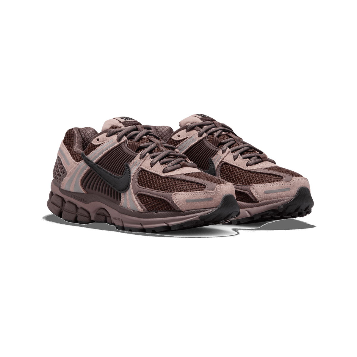 A pair of brown and dusty-pink Nike Zoom Vomero 5 sneakers shown side by side at an angle, with mesh panels, suede overlays, and black Swoosh logos on the sides.