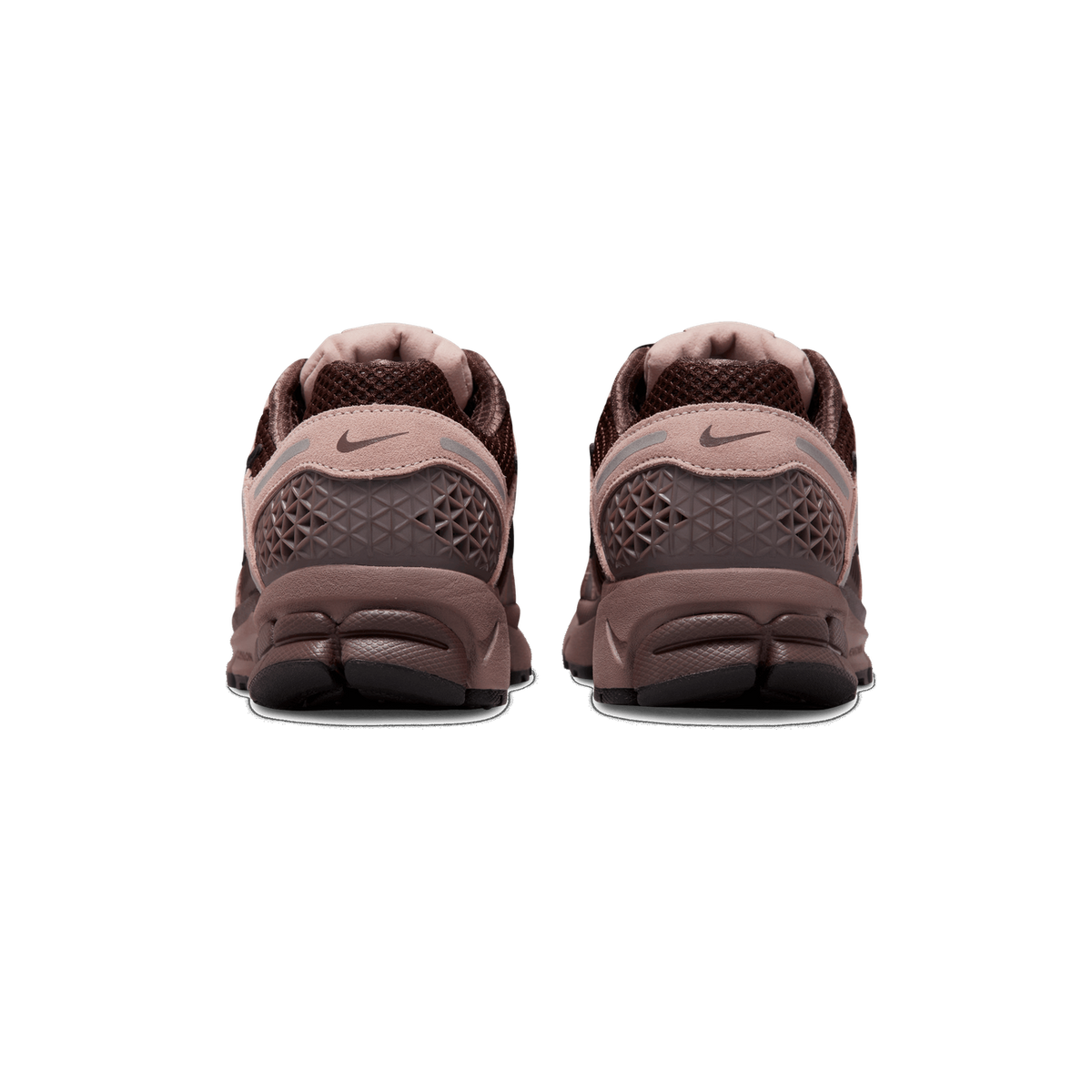 Rear view of a pair of brown and mauve Nike Zoom Vomero 5 sneakers standing side by side, showing the heel counters with Swoosh logos, textured heel panels, and dark brown outsoles.