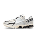 Right lateral view of a Nike Zoom Vomero 5 sneaker in light bone and black with a white swoosh and chunky multi-layer midsole.