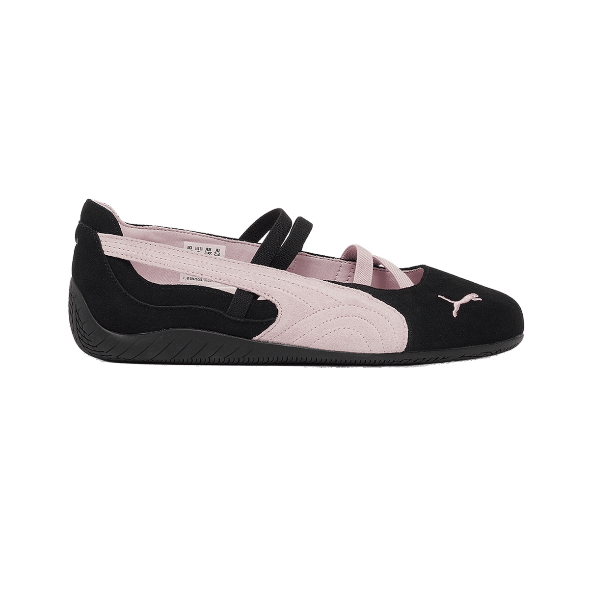 Inside view of a black and pink suede Puma Speedcat ballet flat with crossing straps and a small Puma logo on the toe, toe pointing right