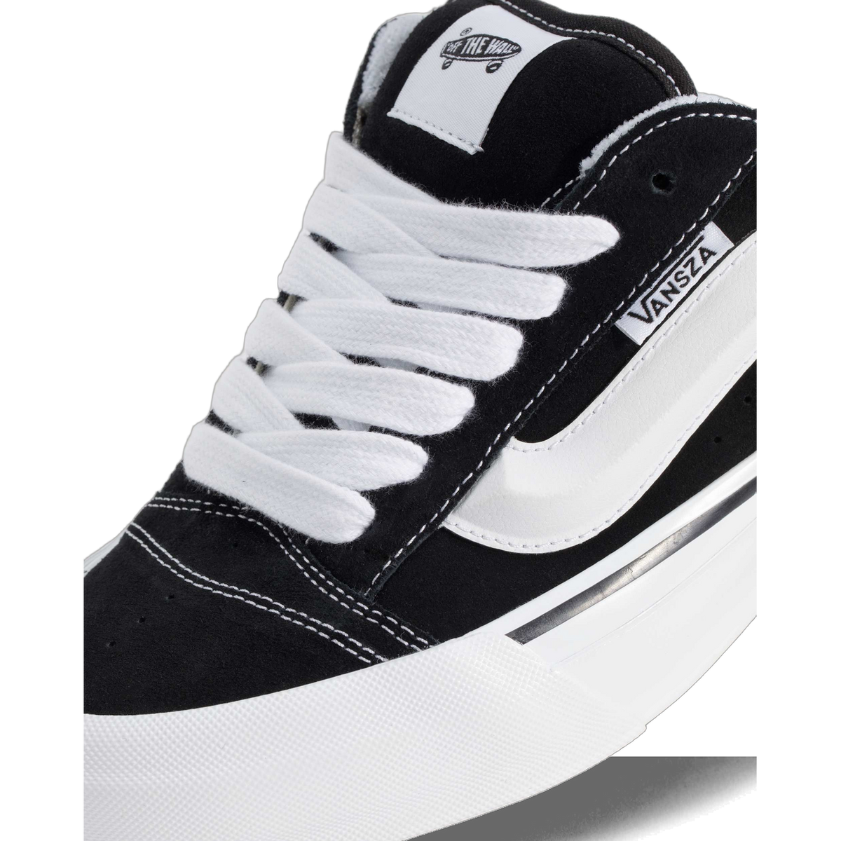 Close-up of a black suede Vans SZA Knu Skool Mule showing the white laces, side stripe, VANSZA tab, and thick white platform sole