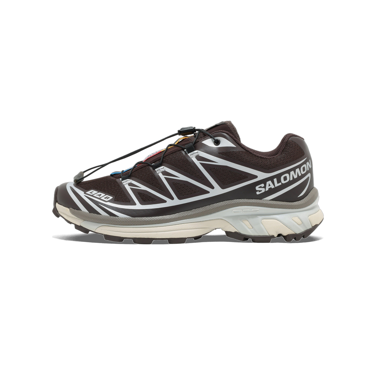 Side view of a dark brown Salomon XT-6 trail running shoe with silver overlays, toggle laces, and a cream and grey sole, toe pointing left.