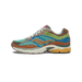 Side view of a Saucony ProGrid Omni 9 sneaker with teal mesh upper, brown suede overlays, blue and green accents, and a yellow and white midsole, toe pointing left