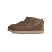 Side view of a brown suede UGG Classic Ultra Mini boot with pull tab at heel and tan rubber sole, toe pointing left.