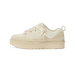 Side view of a beige UGG Lowmel Lo sneaker with thick chunky sole, suede overlays, and patterned laces with a heel pull loop.