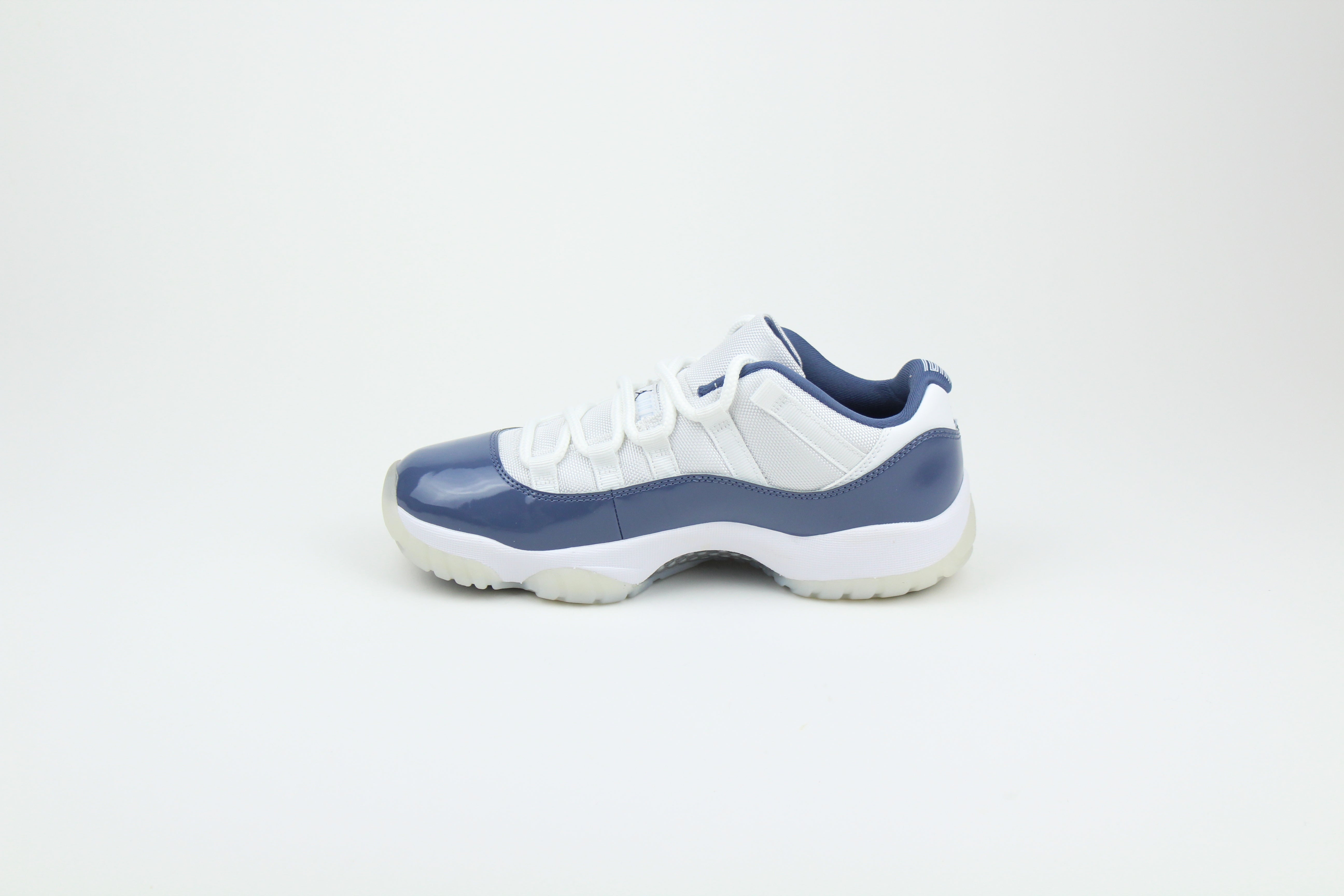 Air Jordan 11 Retro Low Diffused Blue sneakers side view, white leather with blue accents, iconic low-top basketball shoe, premium athletic footwear, stylish and collectible