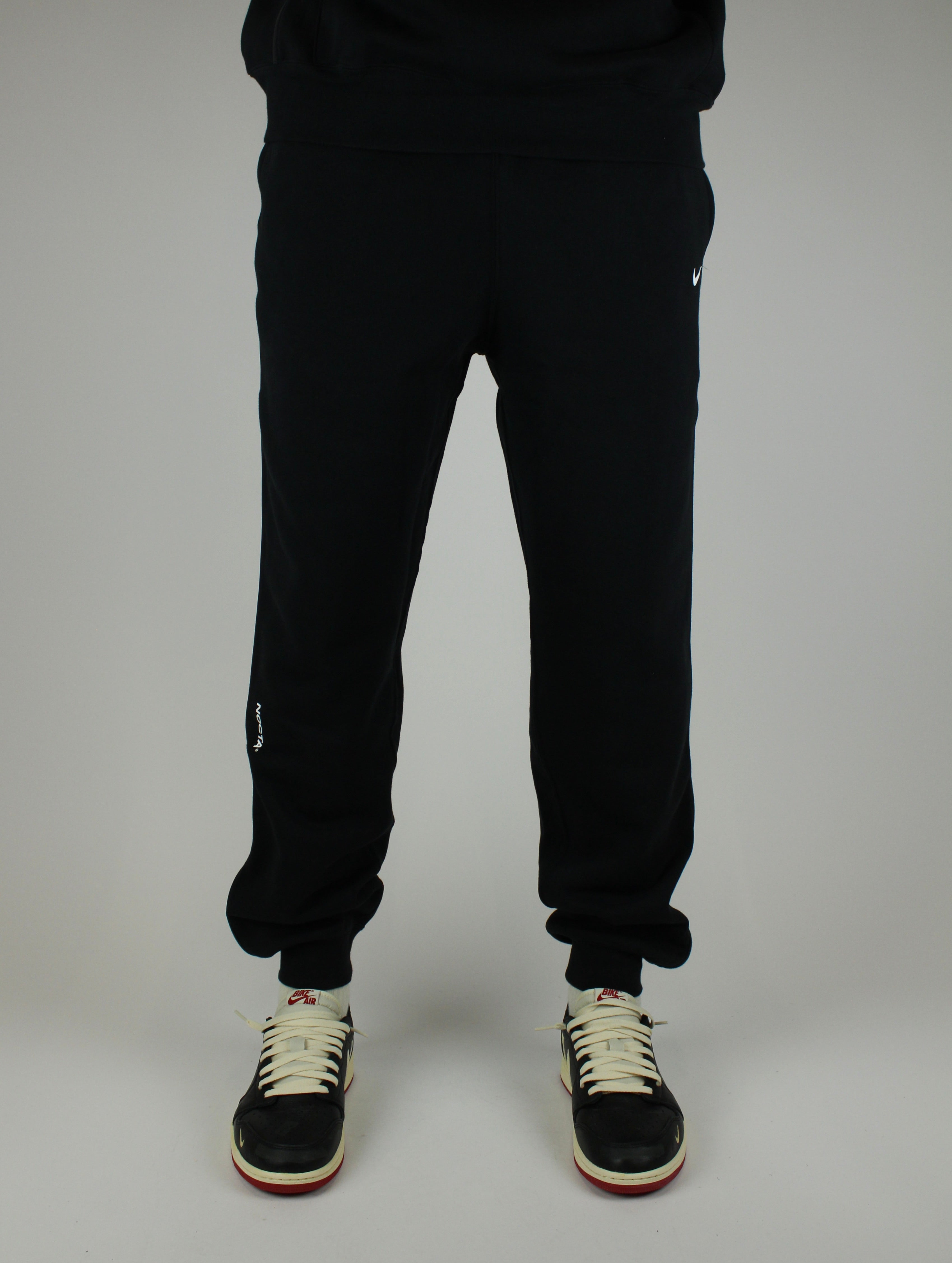 The Nike x NOCTA Open-Hem Fleece Pants Tapered in Black are the definition of effortless utility With a tailored straight-leg fit and clean finish.
