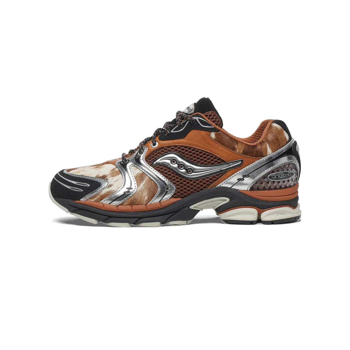 Side view of a Saucony ProGrid Triumph 4 sneaker with brown and white cowhide-textured panels, silver overlays, and a black and gray midsole, toe pointing left.