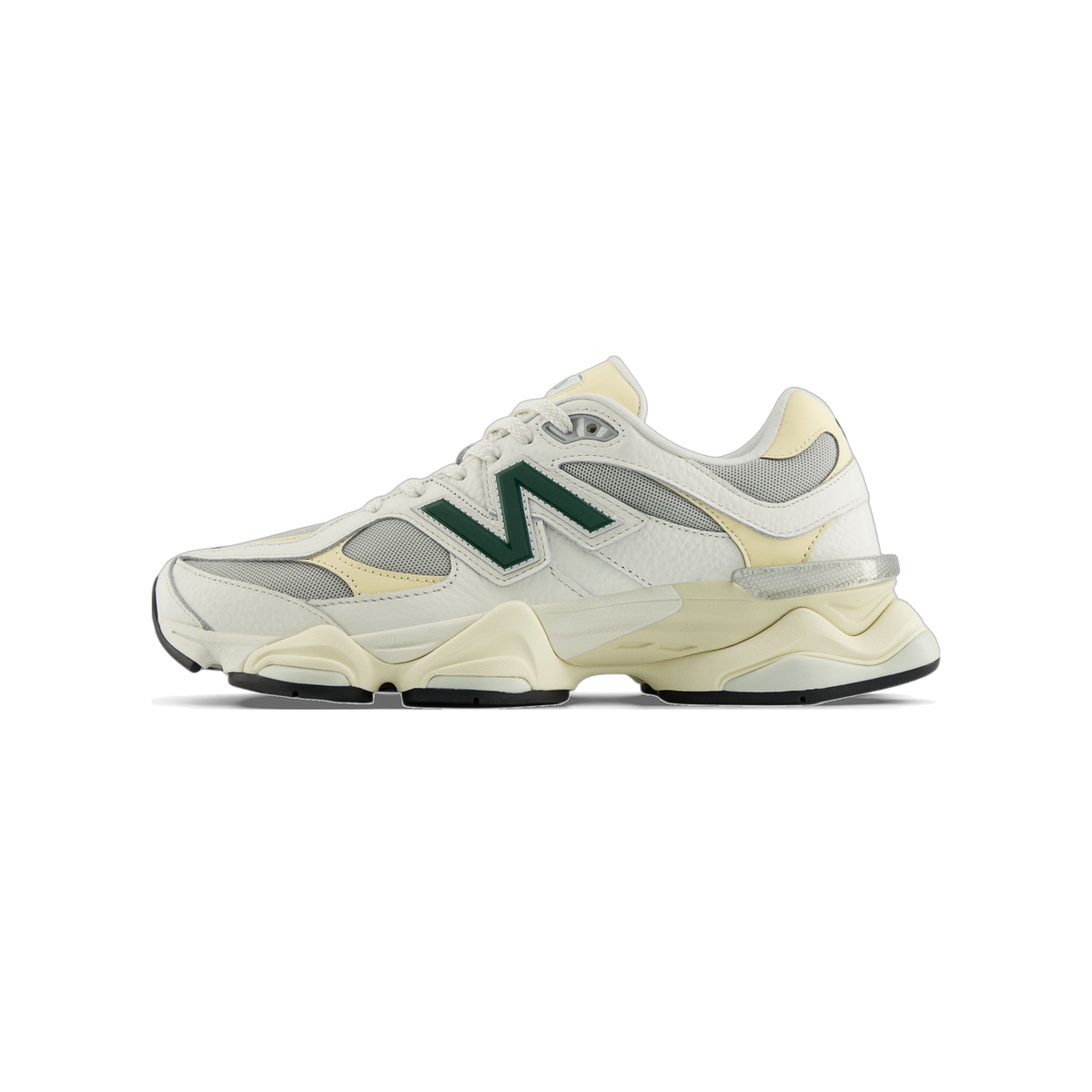 Left side view of a white and pale yellow New Balance 9060 sneaker with a dark green N logo and chunky two-tone sole.
