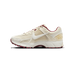 Lateral view of a cream Nike Zoom Vomero 5 sneaker with white swoosh, burgundy lace eyelets and heel trim, and burgundy outsole details.